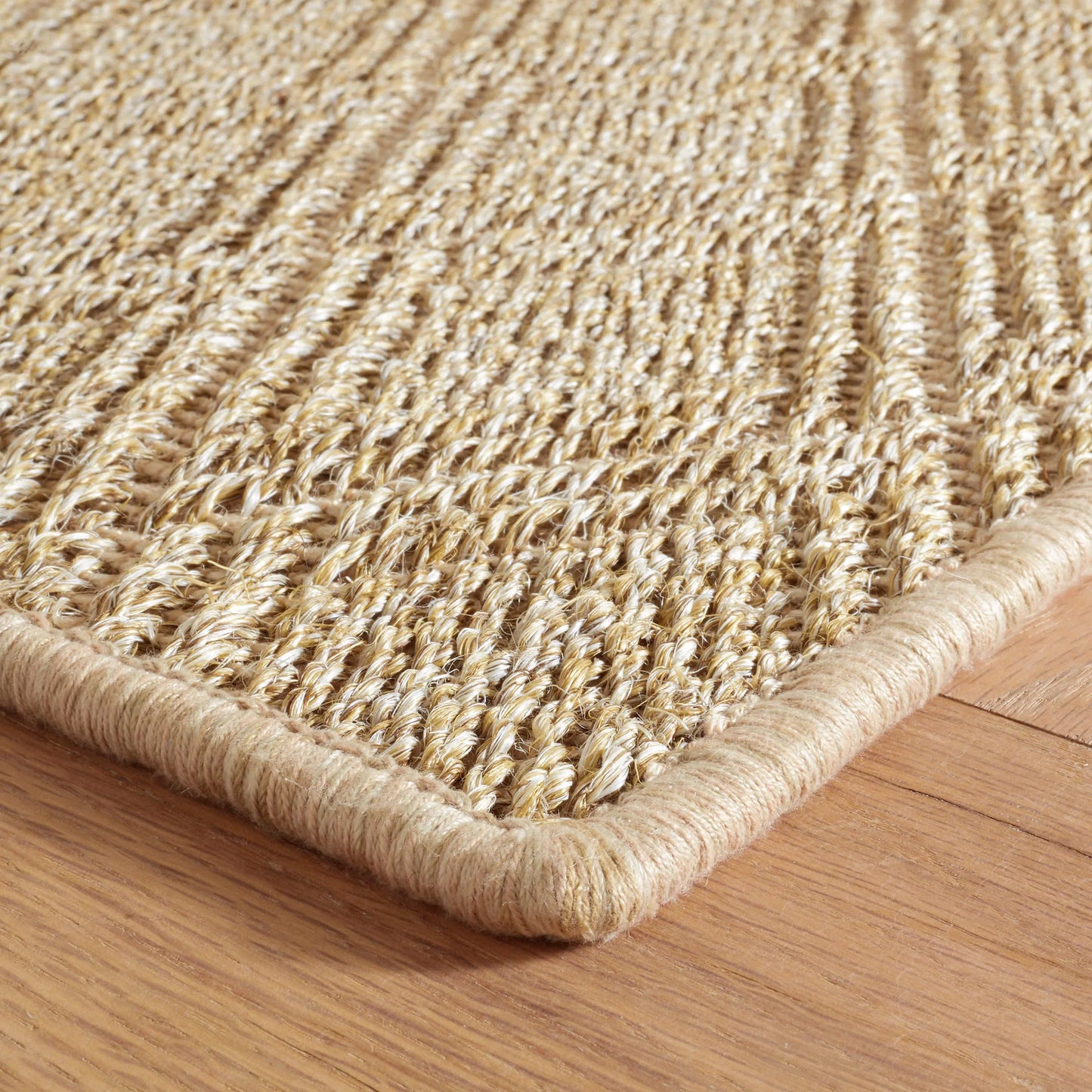 Close-up of the Willa braided woven hemp rug in natural