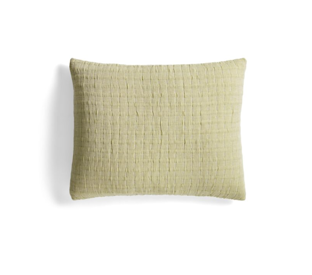 A square decorative throw pillow in a textured, crinkled fabric with a muted sage green color, shown against a plain white background.