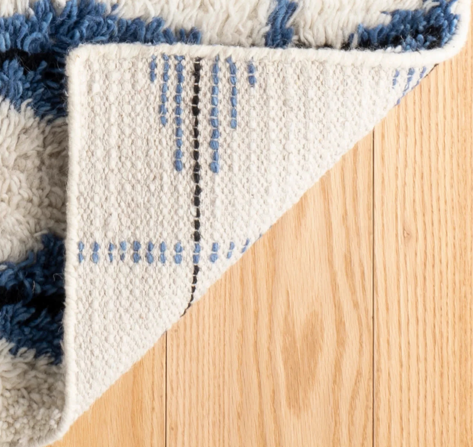 Annie Selke Noma Indigo rug showing high pile and diamond pattern with no rug backing