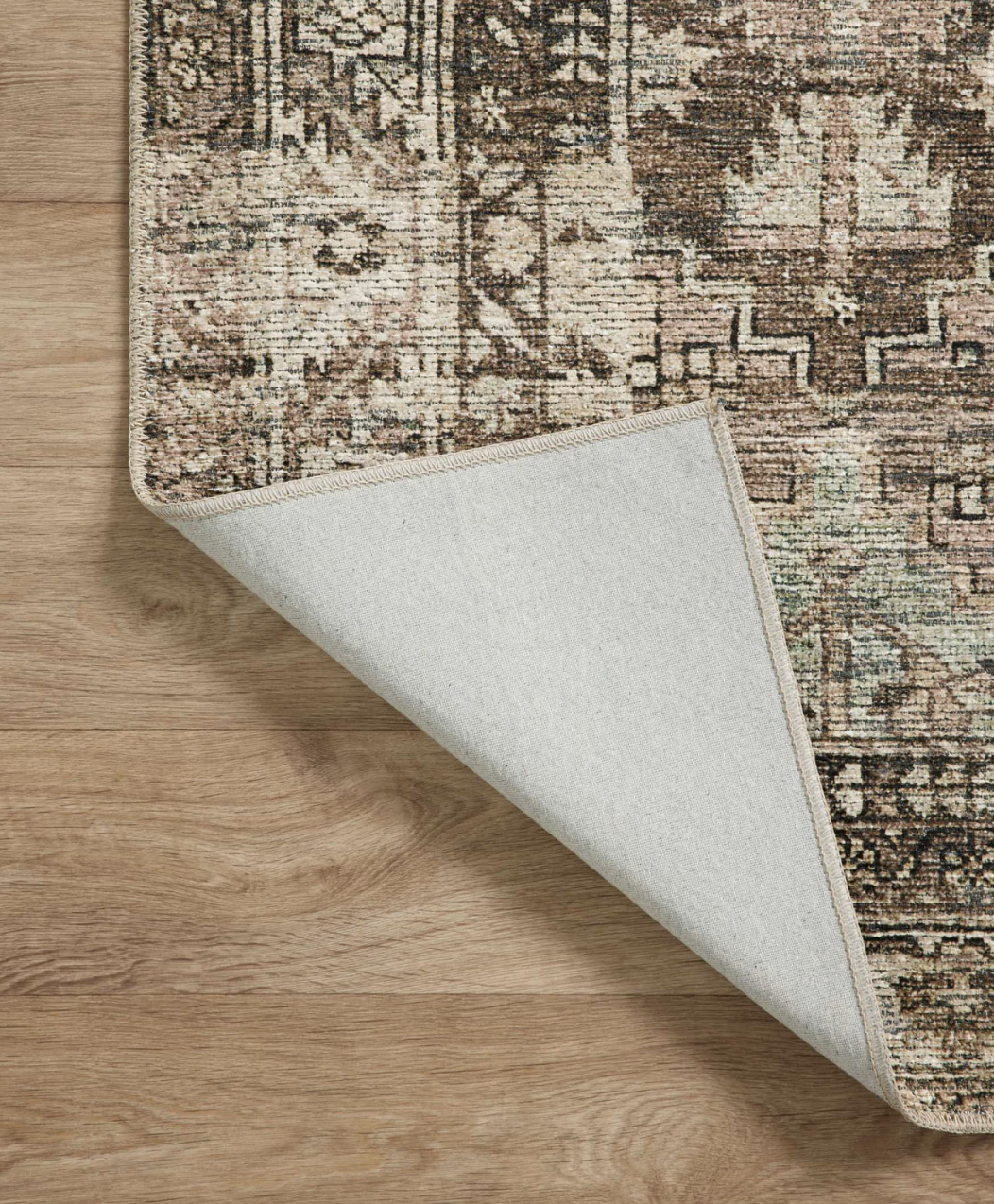 Close-up of the Billie Clay/Sage rug on hardwood floor
