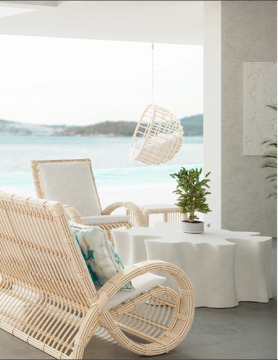 Interior design by Carolina Jasmine featuring woven lounge seating and sculptural outdoor tables in a bright coastal-inspired space