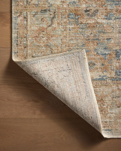 Close-up of the Heritage Ocean/Sand rug variable-pile texture with no rug cushion on wood floor