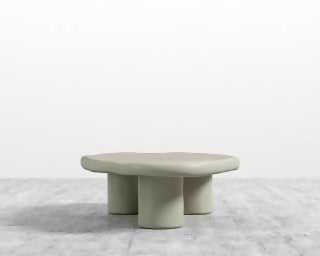 Kara coffee table in alabaster with a soft sculptural shape and rounded pedestal legs