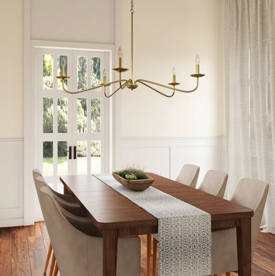 Brass chandelier installed over a dining table in a refined Lowcountry home