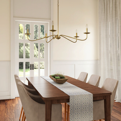 Brass chandelier installed over a dining table in a refined Lowcountry home