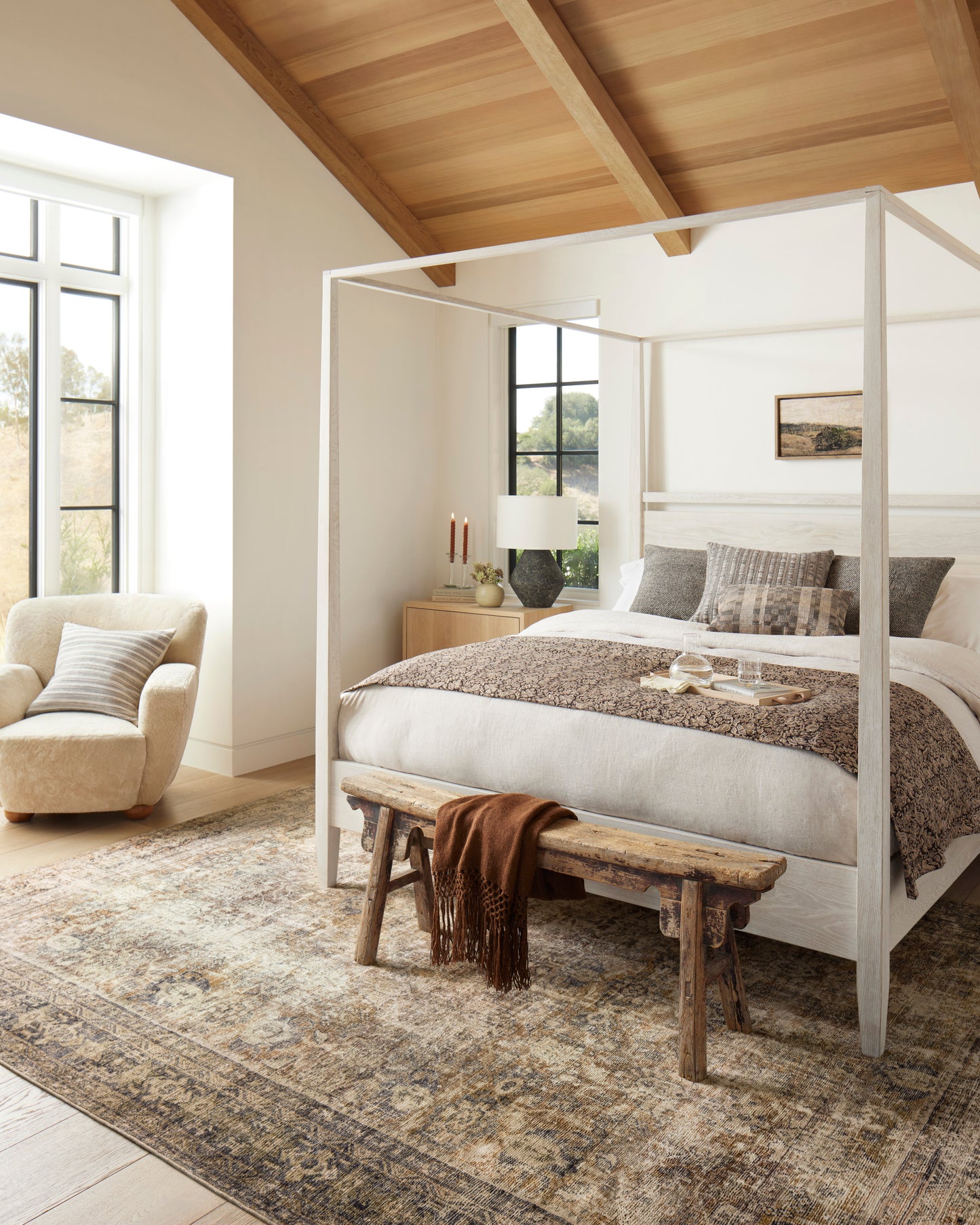 Morgan Sunset/Ink area rug styled in a warm bedroom
