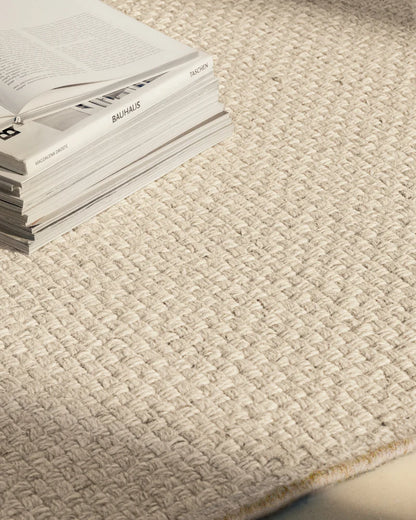 Close-up of the Zero Basket Sand Mix wool rug texture and contrast binding